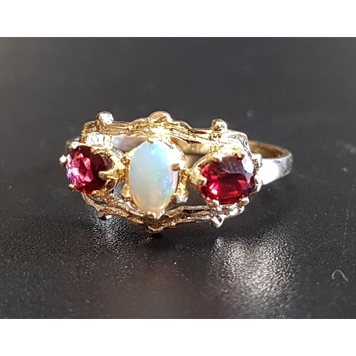 95 - OPAL AND GARNET THREE STONE RING
the central oval cabochin opal flanked by oval cut garnets, in pier... 