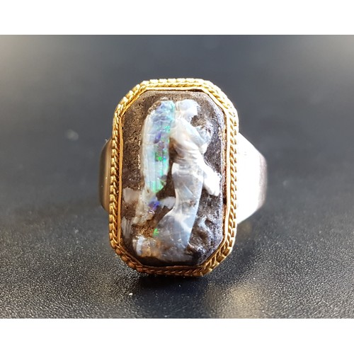 86 - UNUSUAL BOULDER OPAL CARVED CAMEO DRESS RING
the cameo depicting the winged Nike with a serpent at h... 