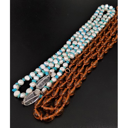 21 - LONG PEARL AND TURQUOISE NECKLACE
with a clear crystal to each end, for tie fastening, approximately... 