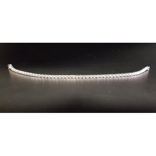 138 - DIAMOND LINE BRACELET 
in eighteen carat white gold, the diamonds totaling approximately 1.3cts, wit... 