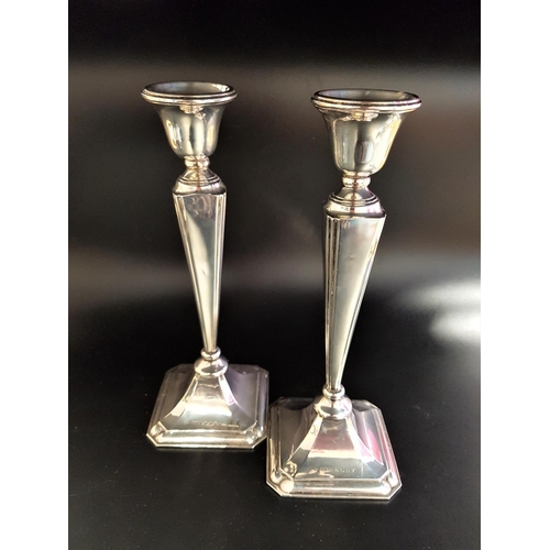 198 - PAIR OF GEORGE V SILVER CANDLESTICKS
with angular tapering stems raised on octagonal bases, Birmingh... 