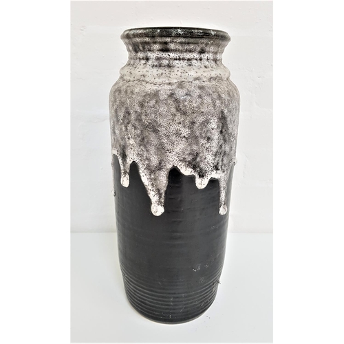 219 - WEST GERMAN POTTERY VASE
with a ribbed black ground with speckled drip over glaze, 40cm high