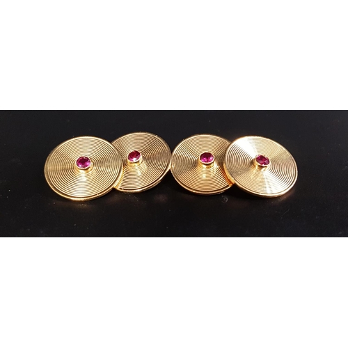 59 - PAIR OF RUBY SET NINE CARAT GOLD CUFFLINKS
each of the circular faces with engraved concentric circu... 