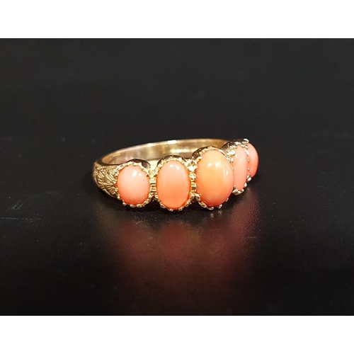 90 - GRADUATED CORAL FIVE STONE RING
the five oval cabochon coral sections flanked by scroll and motif de... 