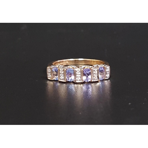 63 - TANZANITE AND DIAMOND RING
the four oval cut tanzanites separated by small diamonds and with further... 