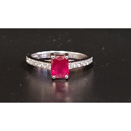 69 - RUBY AND DIAMOND RING
the central emerald cut ruby approximately 1ct flanked by diamond set shoulder... 