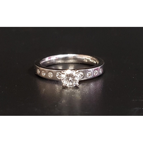96 - DIAMOND SOLITAIRE RING
the round brilliant cut diamond approximately 0.4cts, flanked by four small f... 