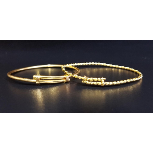 143 - TWO HIGH CARAT GOLD CHRISTENING BANGLES
one marked 916, the other unmarked but testing as 22 carat g... 