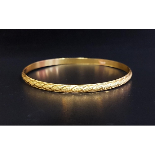 146 - UNMARKED HIGH CARAT GOLD BANGLE
testing as 22 carat, with engraved decoration, total weight approxim... 