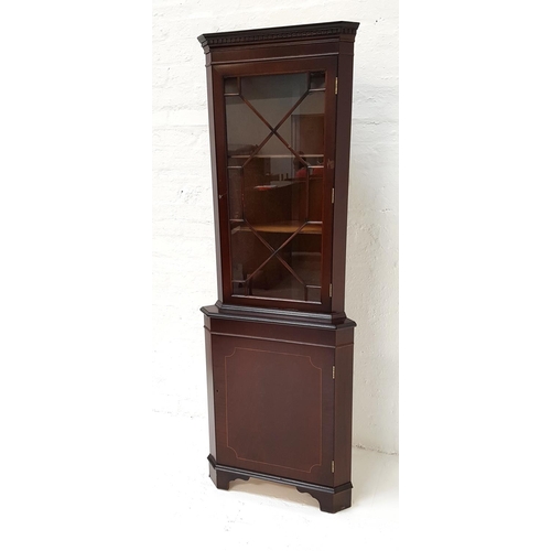 484 - MAHOGANY CORNER CABINET
with a moulded top and dentil cornice above a glazed and beaded door, with t... 