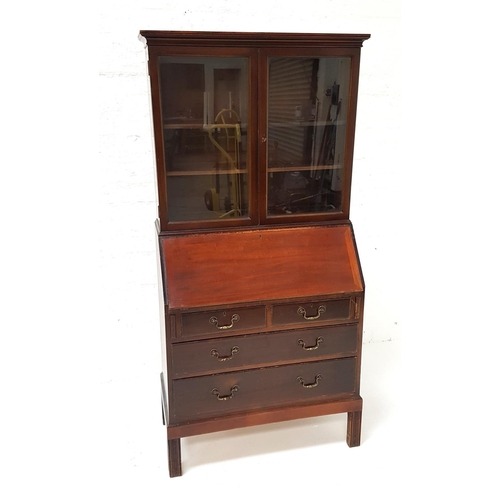 501 - MAHOGANY BUREAU BOOKCASE
with a moulded top above a pair of glass doors with two adjustable shelves,... 