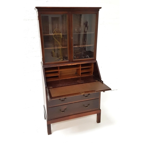 501 - MAHOGANY BUREAU BOOKCASE
with a moulded top above a pair of glass doors with two adjustable shelves,... 