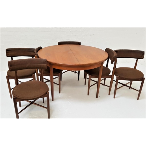 496 - G PLAN CIRCULAR TEAK DINING TABLE AND SIX CHAIRS
the table with a pull apart top revealing a fold ou... 