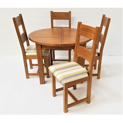 499 - CIRCULAR OAK EXTENDING DINING TABLE AND FOUR CHAIRS
the table with a pull apart top and fold out lea... 