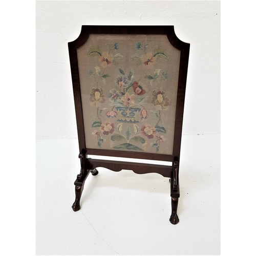 593 - SHAPED MAHOGANY FRAMED FIRE SCREEN
with floral needlework panel, standing on splayed claw and ball f... 