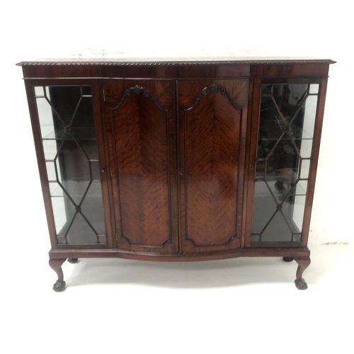 487 - MAHOGANY SERPENTINE SIDE CABINET
with a moulded top above a pair of panelled doors flanked by a pair... 