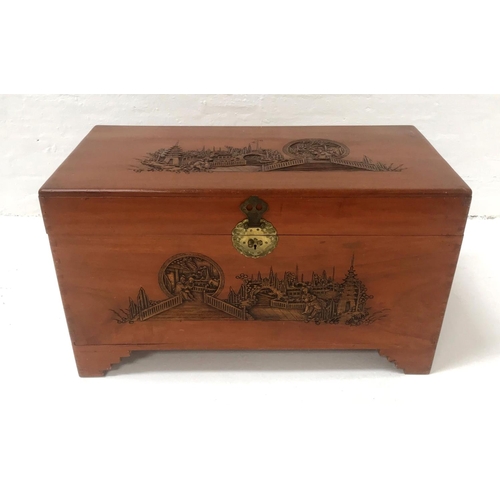 489 - CHINESE CAMPHOR CHEST
with a craved lift up lid and front panel with a decorative brass lock, with c... 