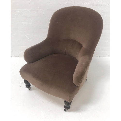 510 - EDWARDIAN ARM CHAIR
with a padded back and seat, standing on turned front supports with later castor... 