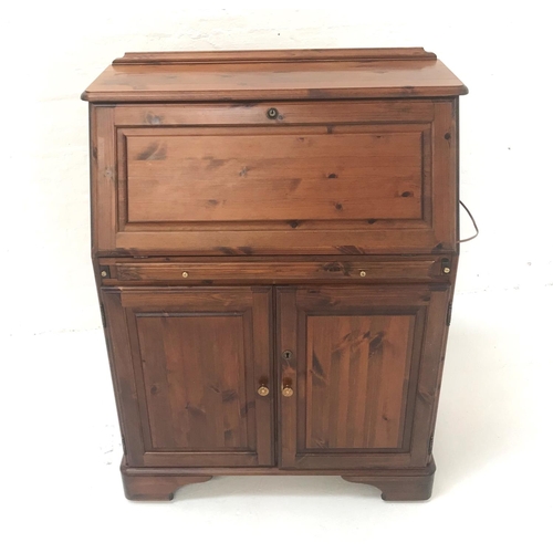 540 - WAXED PINE BUREAU
with a paneled fall flap opening to reveal an illuminated fitted interior above a ... 