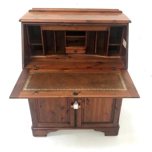 540 - WAXED PINE BUREAU
with a paneled fall flap opening to reveal an illuminated fitted interior above a ... 