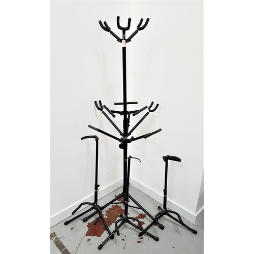 384 - SELECTION OF GUITAR STANDS
including three metal single stands and a height adjustable two tier stan... 