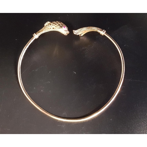 23 - NINE CARAT GOLD FISH DECORATED BANGLE
the finials with detailed fish body and tail respectively, wit... 