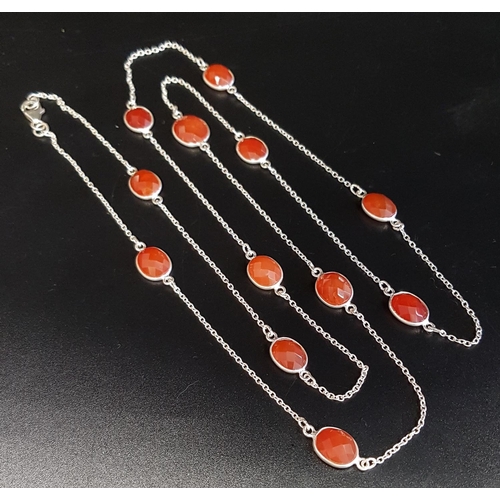 131 - CARNELIAN SET SILVER NECKLACE
the twelve faceted carnelians separated by silver chain sections, 94cm... 