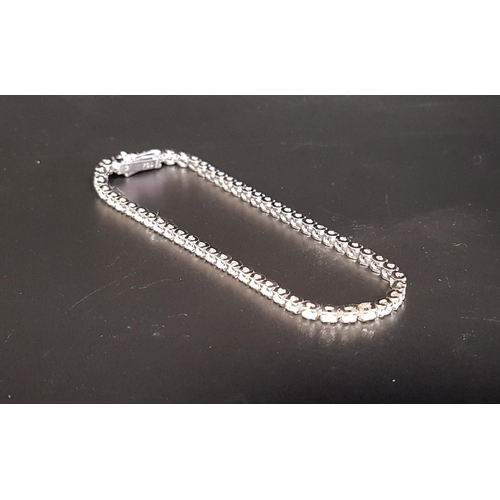 138 - DIAMOND LINE BRACELET 
in eighteen carat white gold, the diamonds totaling approximately 1.3cts, wit... 