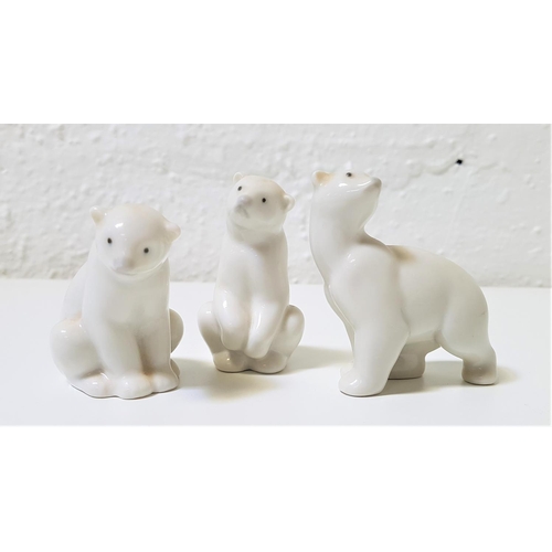 268 - THREE NAO PORCELAIN FIGURINES OF POLAR BEAR CUBS
two seated, 6cm and 7.5cm high, and the other on al... 