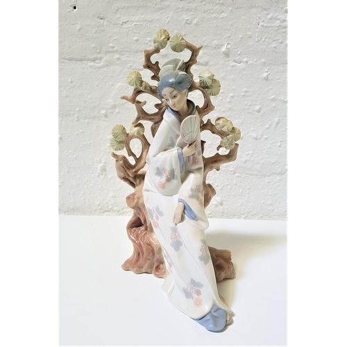 272 - LARGE LLADRO PORCELAIN FIGURINE
of a Geisha with a fan seated by a tree, 31cm high