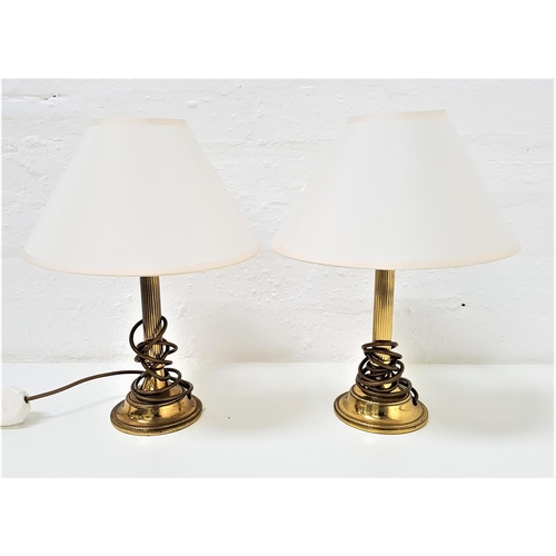 524 - PAIR OF BRASS TABLE LAMPS
raised on circular bases with reeded columns and shaped cream shades, 39cm... 