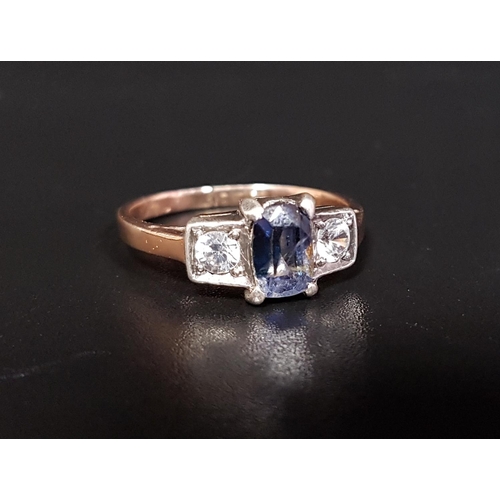 35 - BLUE AND WHITE SAPPHIRE THREE STONE RING 
the central blue sapphire flanked by a round cut white sap... 