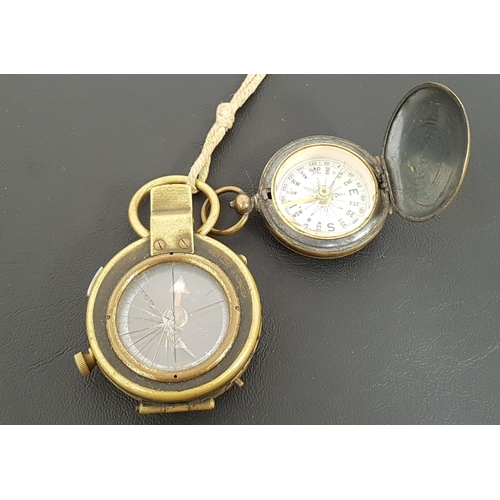 311 - WWI MILITARY MARCHING COMPASS
in brass and marked F-L No;126052 1918, together with a brass pocket w... 