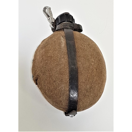 320 - GERMAN WWII WATER BOTTLE
of oval form in aluminium with a felt cover with stud fastening and leather... 