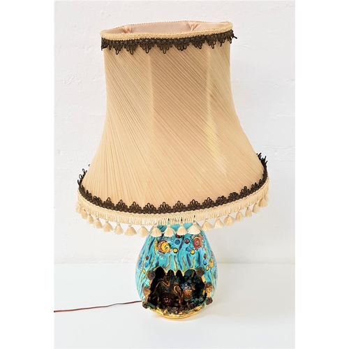 212 - 1960'S KERIMA GUALDOT POTTERY LAMP
decorated in aquamarine blue with vibrant fish, with a cut out se... 