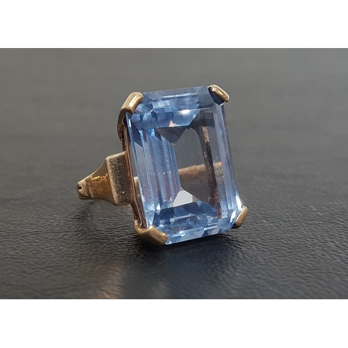 63 - IMPRESSIVE BLUE TOPAZ COCKTAIL RING
the large emerald cut topaz measuring 20mm x 15mm x 8.5mm, on te... 