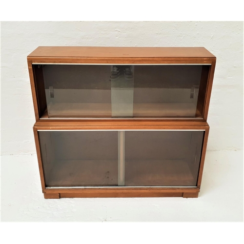 471 - MINTY TEAK BOOKCASE
with a moulded top above a pair of glass sliding doors above another pair of gla... 