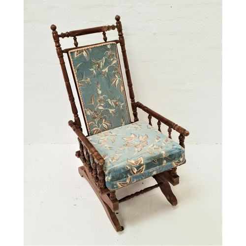 470 - EDWARDIAN ROCKING CHAIR
with ring turned decoration and a padded back with matching seat cushion, on... 