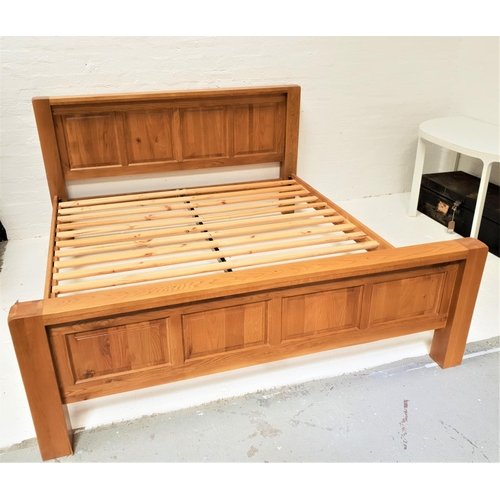 492 - LIGHT OAK KING SIZE BED
with a panelled head and footboard and slatted base, 194cm wide