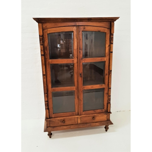 496 - TEAK CABINET
with a moulded cornice above a pair of arched glass panel doors, opening to reveal shel... 