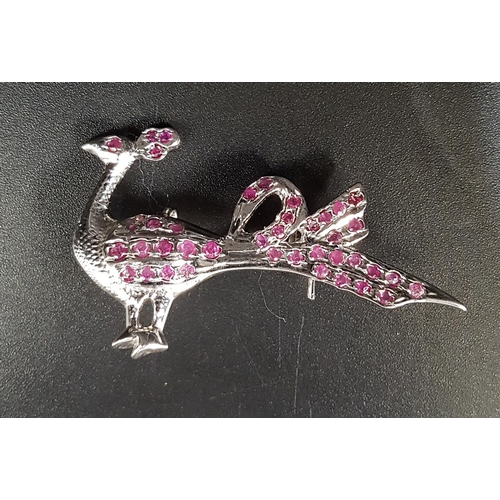 22 - RUBY SET PEACOCK BROOCH 
in silver, approximately 4.7cm wide