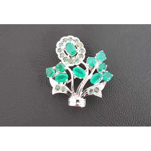 152 - EMERALD SET FLORAL DESIGN BROOCH/PENDANT
the oval and round cut emerald in silver mount, approximate... 