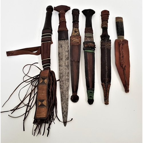 369 - SIX AFRICAN DAGGERS
five with double edged blades, all with leather wrapped handles, five with leath... 