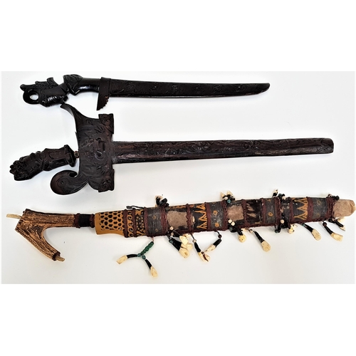 374 - BORNEO DAYAK HEADHUNTERS SWORD
with a 45cm blade with carved decoration and a replaced antler handle... 