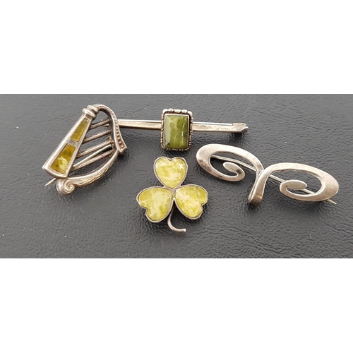 9 - FOUR SILVER BROOCHES
comprising a green agate set harp brooch; another green agate set three leaf cl... 