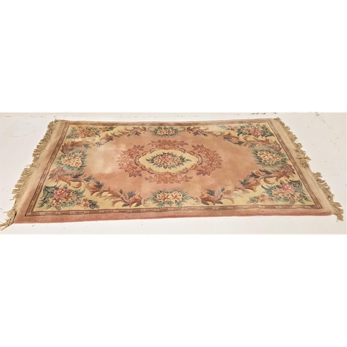 480 - CHINESE WASH RUG
with a pale pink ground and floral motifs, fringed, 244m x 152cm excluding fringe