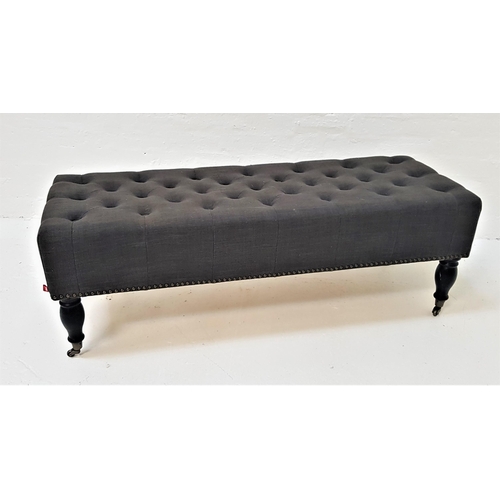 503 - THE ONE BUTTON STUDDED STOOL
in oblong textured grey covered material, standing on black stained tur... 