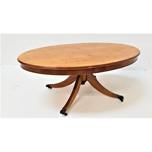 530 - YEW WOOD OCCASIONAL TABLE
with an oval tilt top, on a turned column with four outswept reeded suppor... 