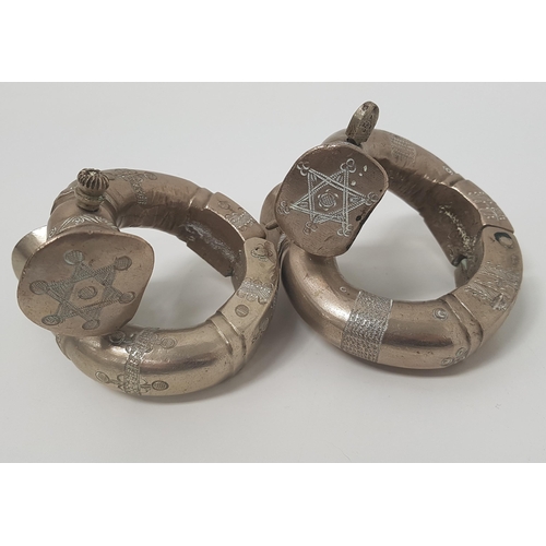 108 - PAIR OF AFRICAN WHITE METAL HINGED BANGLES
with chased decoration and pin closure (2)