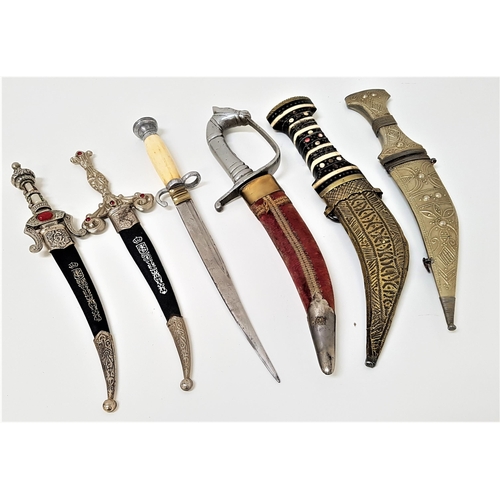 370 - TWO SPANISH DAGGERS
each with a curved blade and decorative handle set with red glass beads, two Mid... 